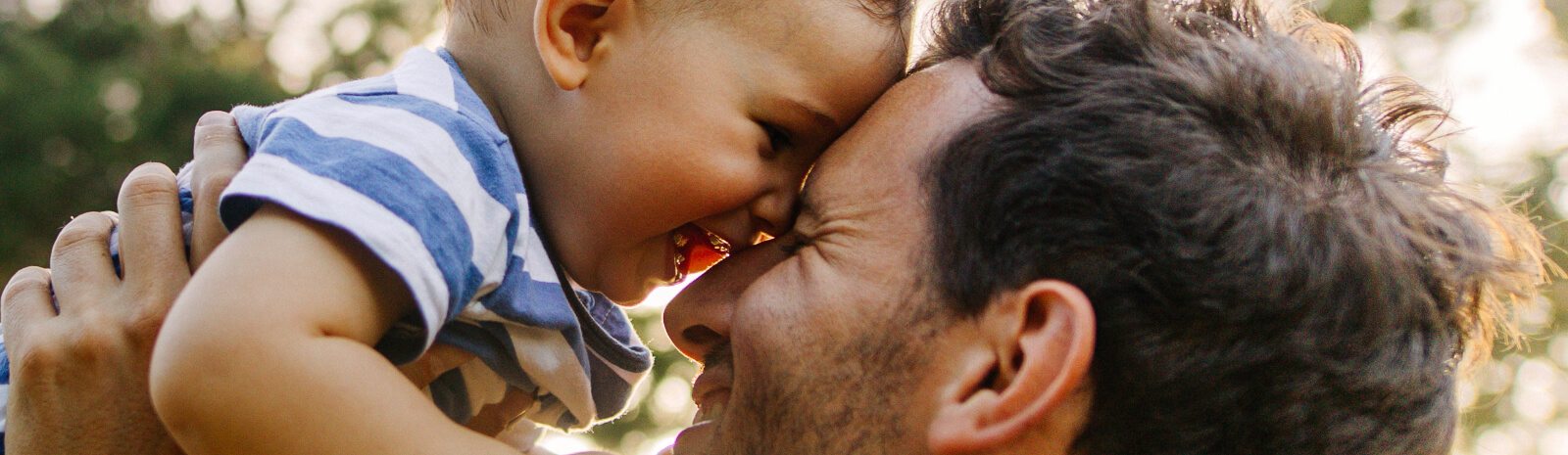 Father holding laughing baby